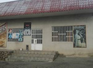 Shop assistant shows list of debtors to "Yes and No" campaign members