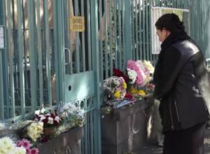 Flowers and candles in front of Embassy of France