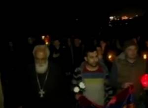 Procession of Silence: People march to Yerablur with numerous lit candles