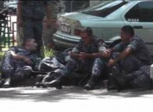 Policemen on Khorenatsi Street try to find shelter from scorching rays of sun