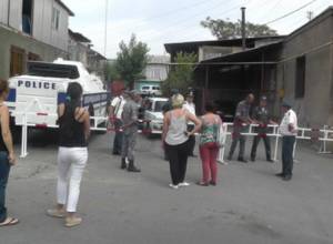 Residents stay under open skies after being displaced from their homes because of police building standoff