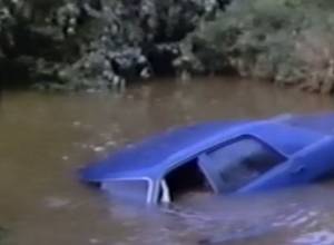 One dies as car falls into river