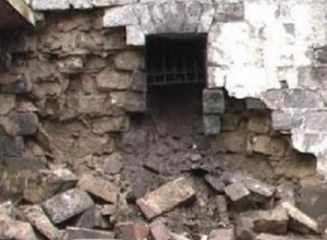 Wall of bathroom collapses and damages car