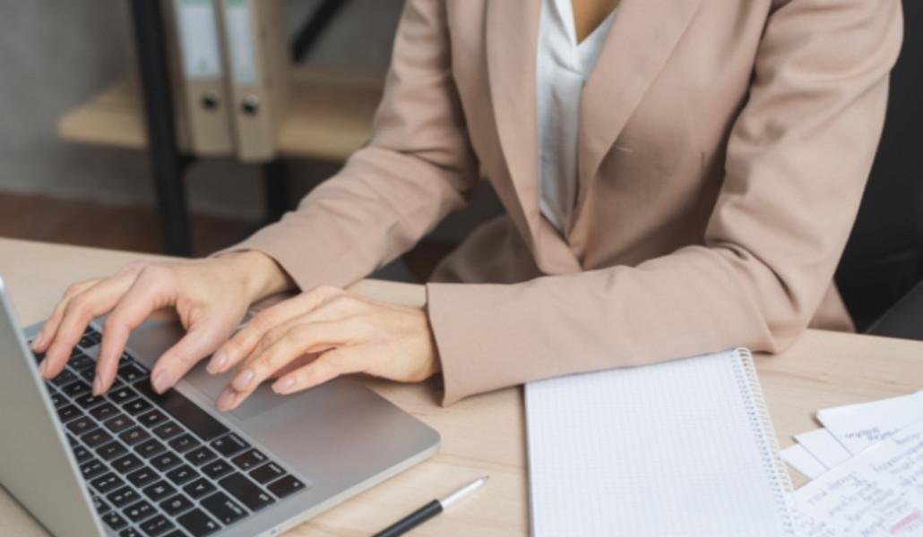 1603353250_close-up-businesswoman-s-hand-typing-laptop-with-pen-diary-spiral-notepad-wooden-table_23-2148029052